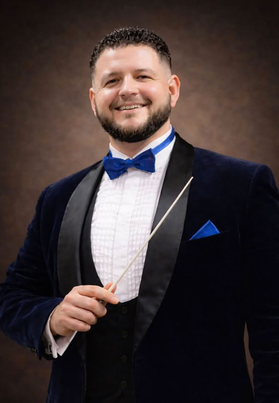 Photo of Adam Whittle holding conductor's baton.